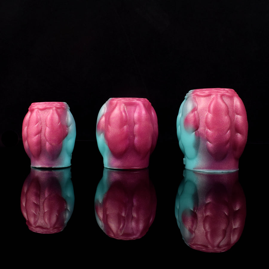 Dragon knot sheath sleeve extender, pink with teal sections, textured sculpted pattern.