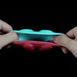 Teal and pink dragon knot sheath sleeve extender flexed lengthwise between hands