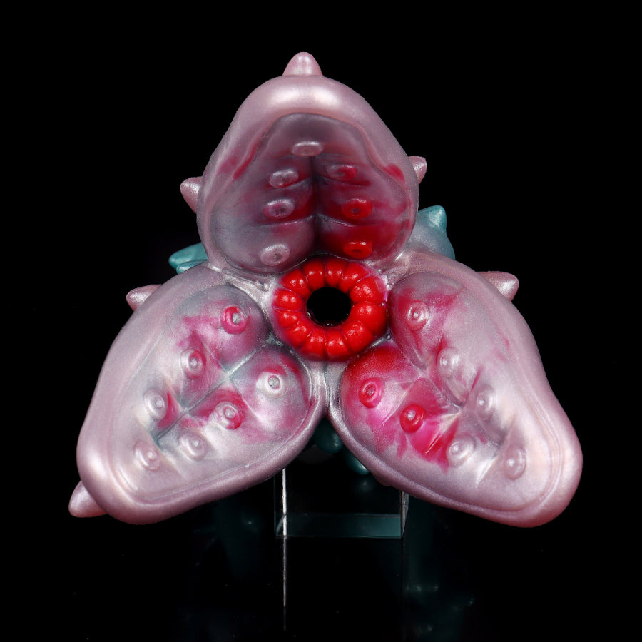 Pink and teal monster stroker sleeve, flower-like red center ring opening