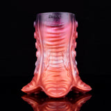 Front view of pinkish-red tentacruel stroker with tentacle skirt detail