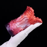 Red tentacle stroker held in white glove, glossy ridged alien texture