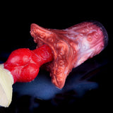Red tentacle stroker with open tip and ridged tentacle base on blue surface