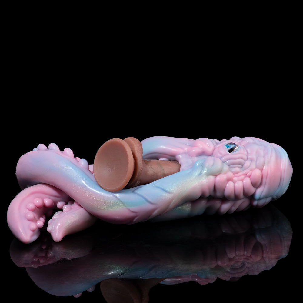 Pastel octopus figurine with curled tentacles and small eye, lying on its side