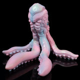 Pastel octopus figurine standing upright with curled tentacles and textured surface