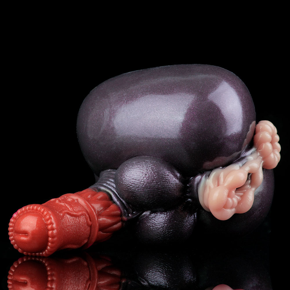 Adult novelty toy close-up of dark gray body with red accent base and pink details