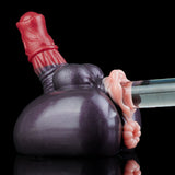 Adult novelty toy angled view with dark gray body, red top, and pink end attachment