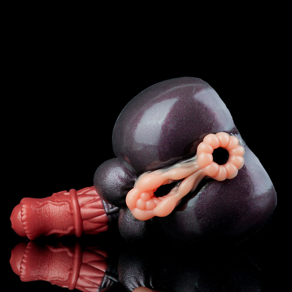 Adult novelty toy close-up with dark gray body and pink detail opening