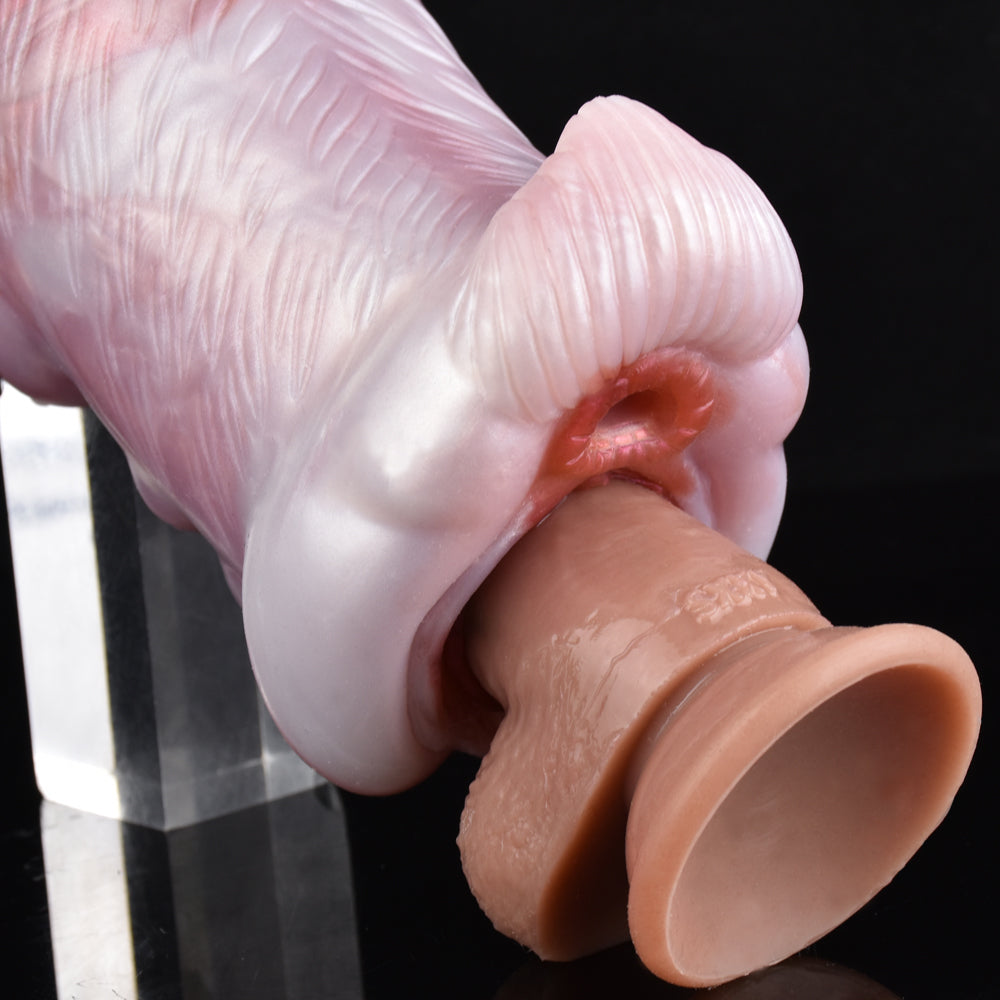 Close-up of canine stroker tip with opening, shown near a second insert