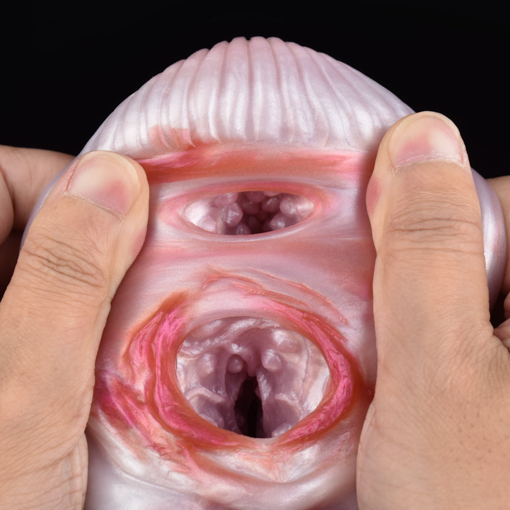 Front view of a pink two-hole canine stroker with ribbed top