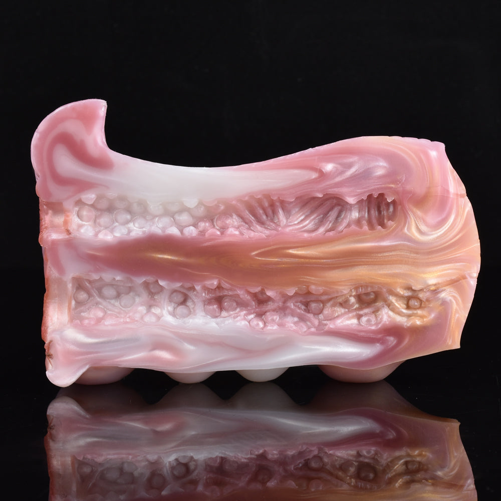 Pink canine stroker insert with molded inner channels and textured surface