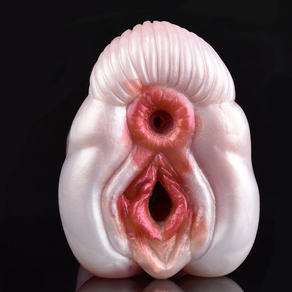 Close-up of two circular openings on a pink canine stroker