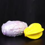 Dragon Egg male stroker with yellow star-shaped attachment on side, pale textured surface