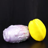 Dragon Egg male stroker with yellow oval star accessory, pale textured cylinder