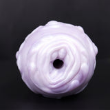 Dragon Egg male stroker: rounded end with central dark opening, pale textured finish