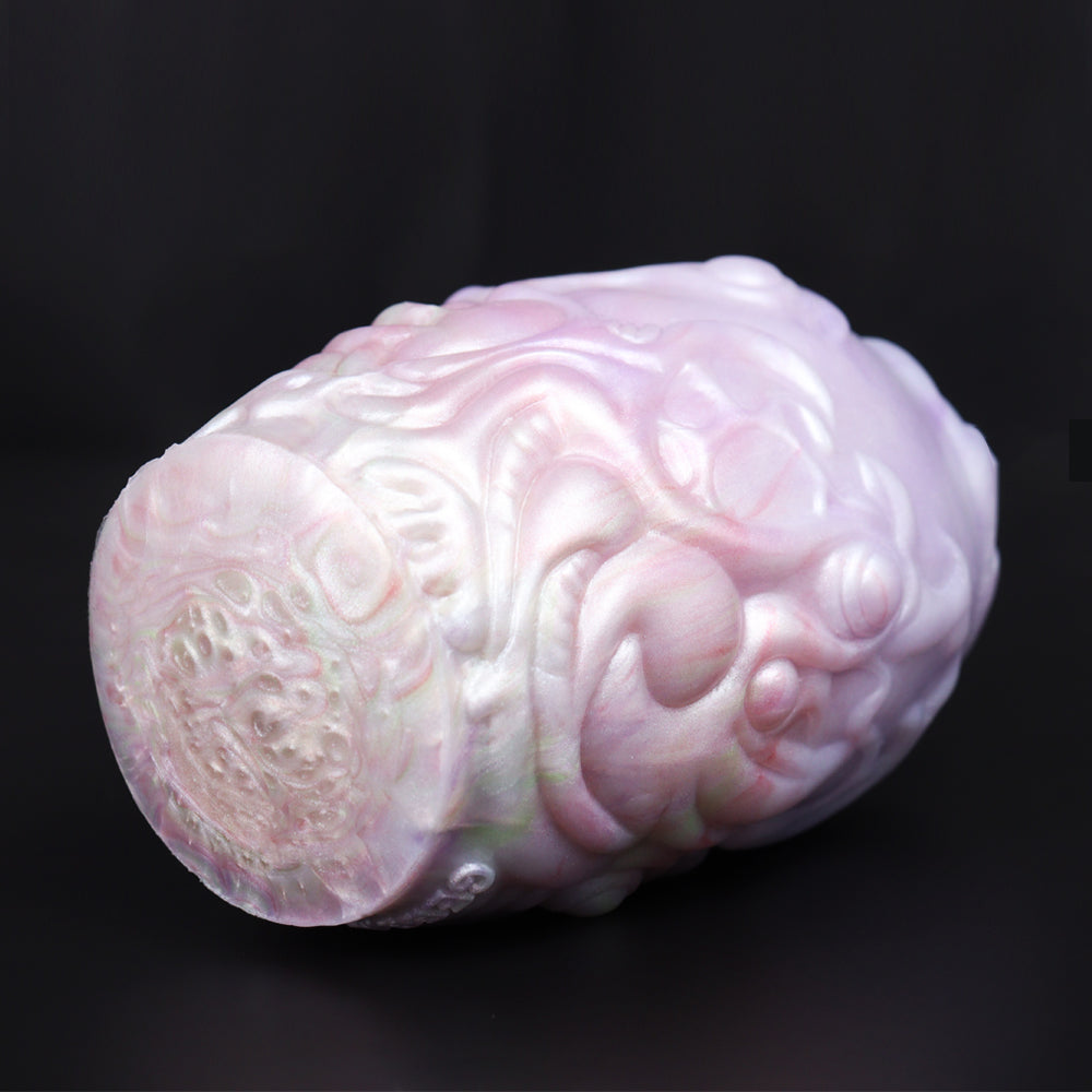 Dragon Egg male stroker with yellow star-shaped accessory, close side of pale textured body