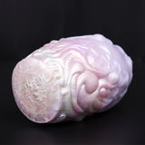 Dragon Egg male stroker with yellow star-shaped accessory, close side of pale textured body