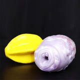 Dragon Egg male stroker with yellow star-shaped attachment, pale textured body