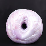 Pink textured pocket cup masturbator with circular opening and inner ridges
