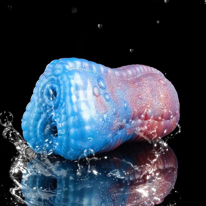 Blue-and-pink dragon male stroker with droplets on the scaly surface