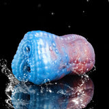 Blue-and-pink dragon male stroker with droplets on the scaly surface