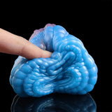 Coiled blue dragon male stroker with scaly spiral texture and partial opening