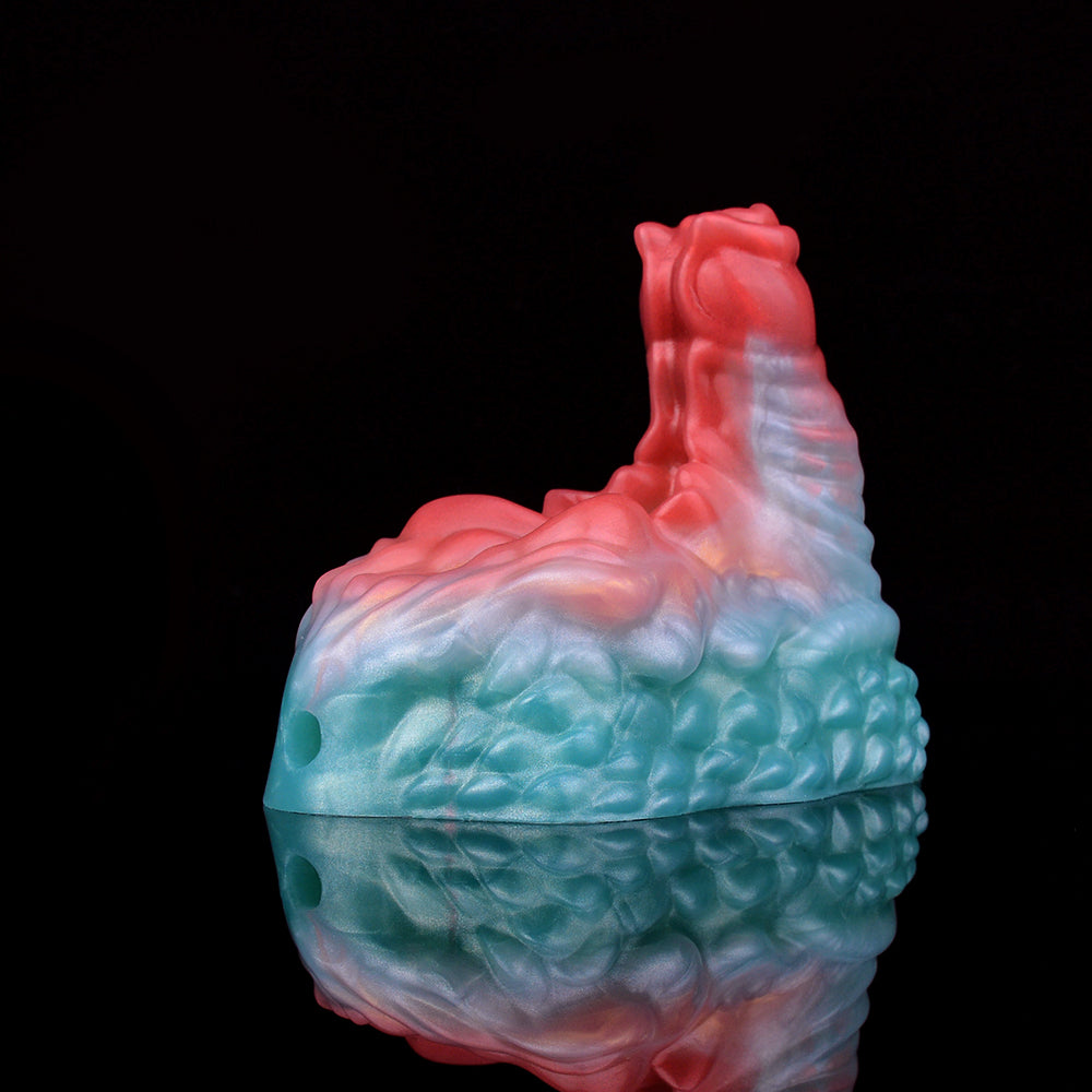 Ticus grinder toy side view, teal-blue textured base with red top