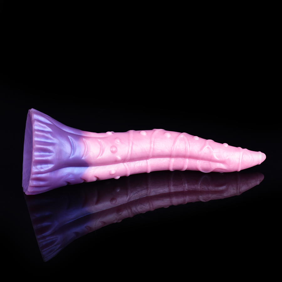 Large silicone tentacle dildo, side view, pink body, purple base fin, reflective glossy surface.