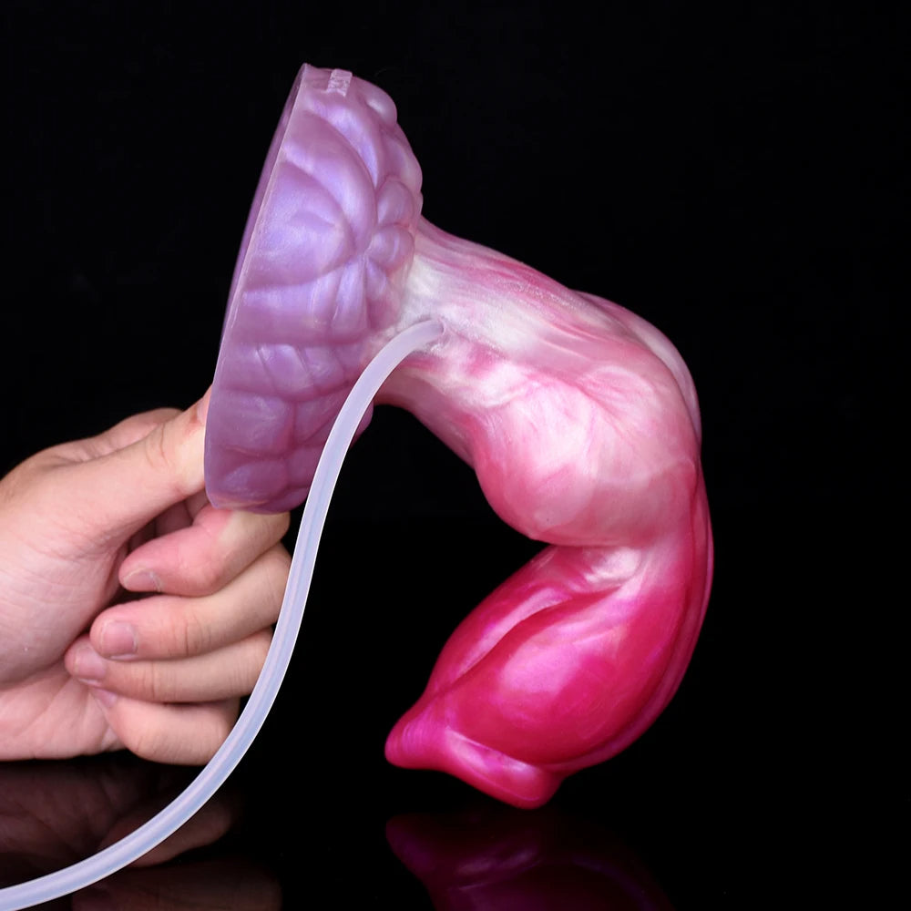 Turuk dog dildo held in hand, pink and purple, curved hose connected