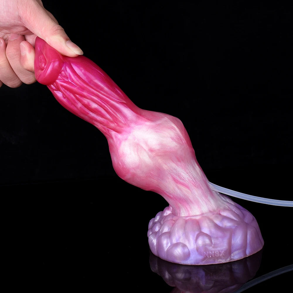Turuk dog dildo close-up end, held by hand, hose connection visible