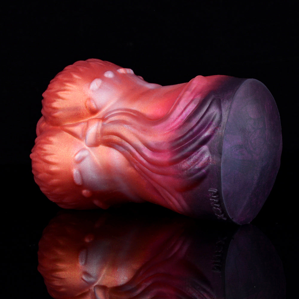 Red-to-purple textured stroker toy, rounded tip end view