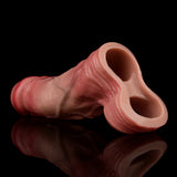Light pink cock extender sleeve with scrotum ring, close-up of openings