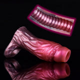Magenta-pink cock sleeve extender pair showing curved shape and hollow opening