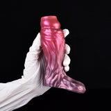Fantasy cock sleeve extender in magenta-pink with textured ridges, worn with white gloves