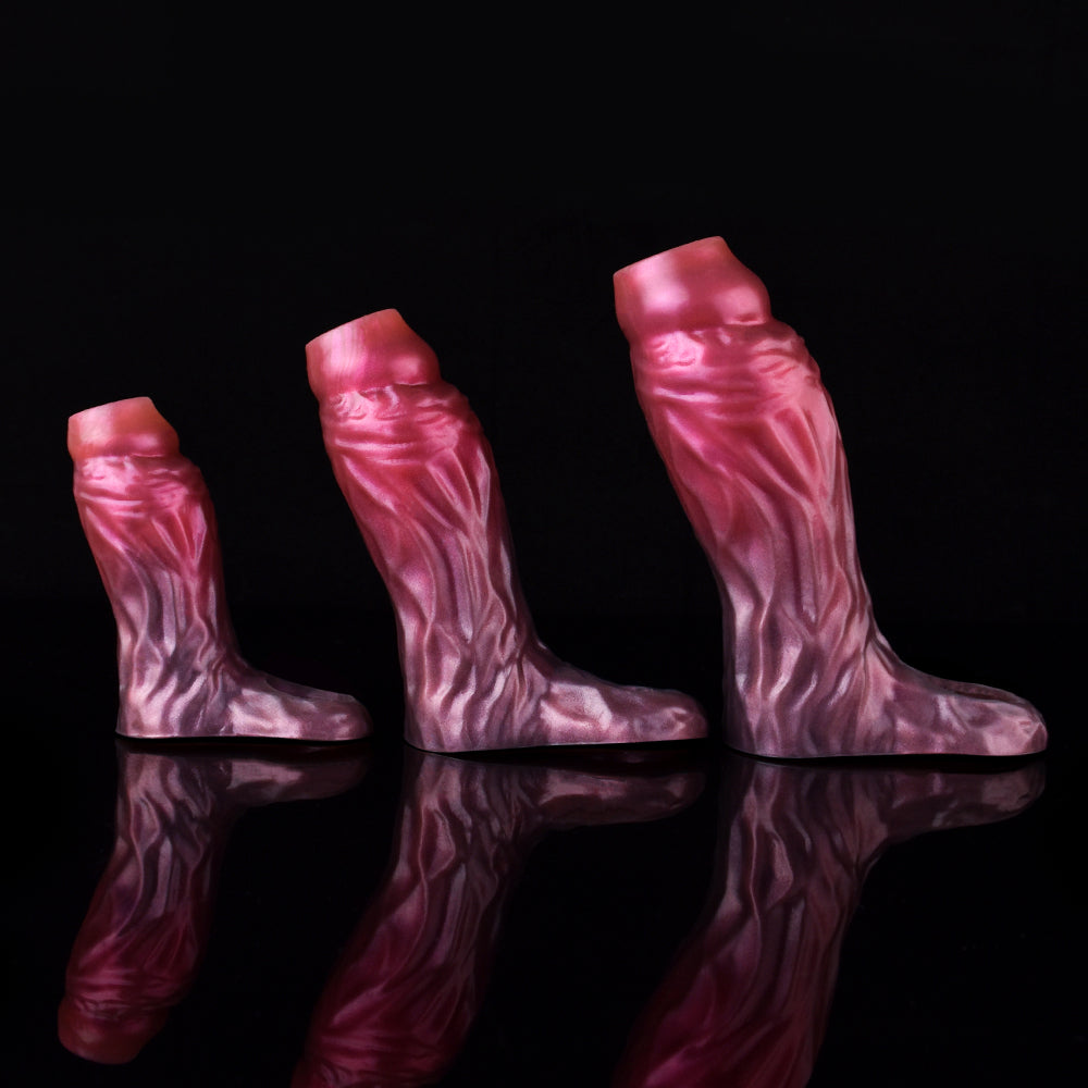 Three magenta-pink cock sleeve extenders with textured pattern, different lengths