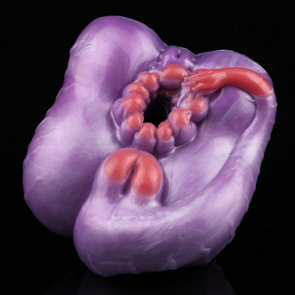 Purple silicone novelty toy with open center and red crescent-shaped detail