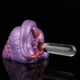 Purple silicone novelty toy with red inner detail and clear applicator tube