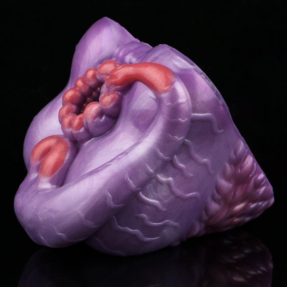Purple silicone novelty toy with red bead cluster and curved red exterior detail