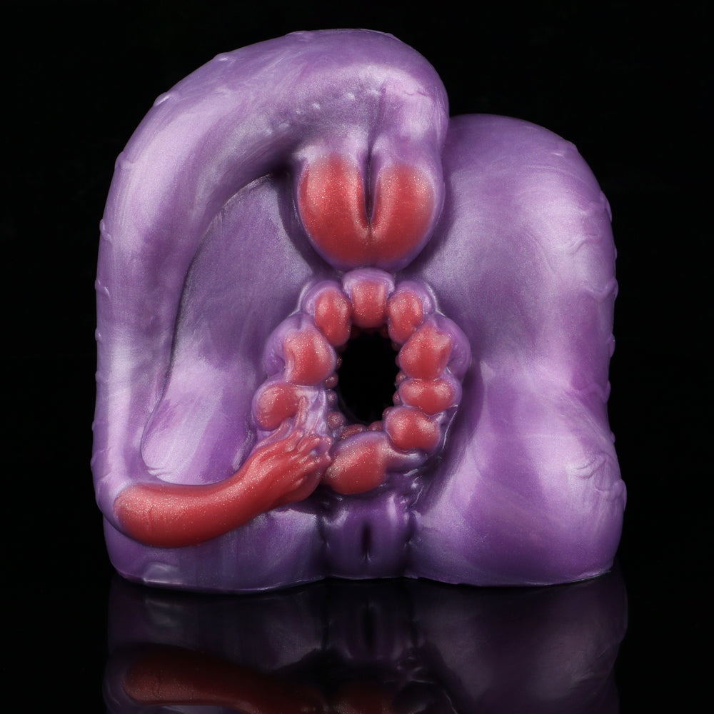 Purple silicone novelty toy with open center, red top tip, and red bead ring
