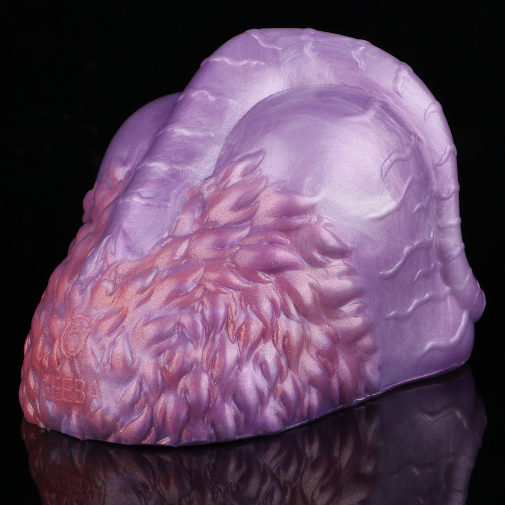 Purple silicone novelty toy with textured purple exterior and red side detail
