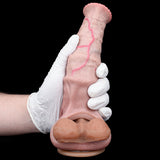 Pink textured cock sleeve/penis sheath with red seam lines, held by gloved hands