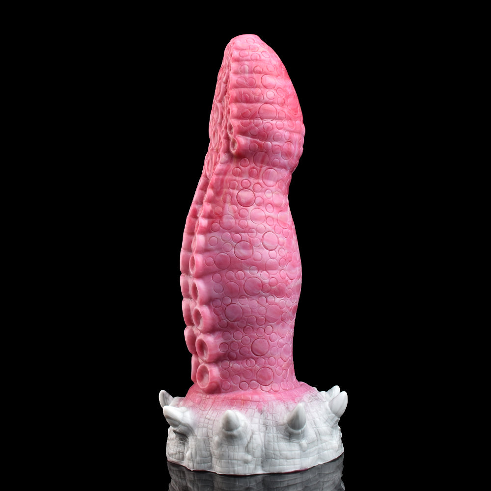 Pink monster tentacle vibrator side view with raised textured pattern and white base fins