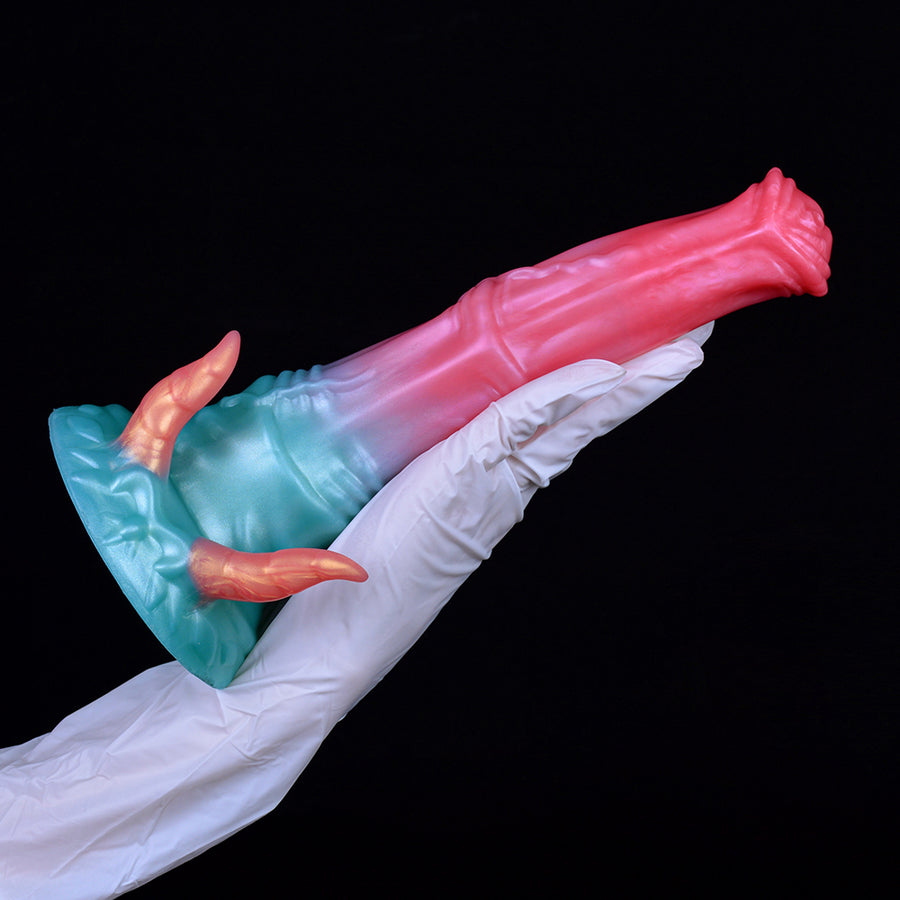 Pink-and-teal horse-shaped dildo with orange horn tips, shown sideways.