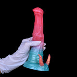Dildo with demon horns held upright, pink shaft and teal base with two orange horn spikes