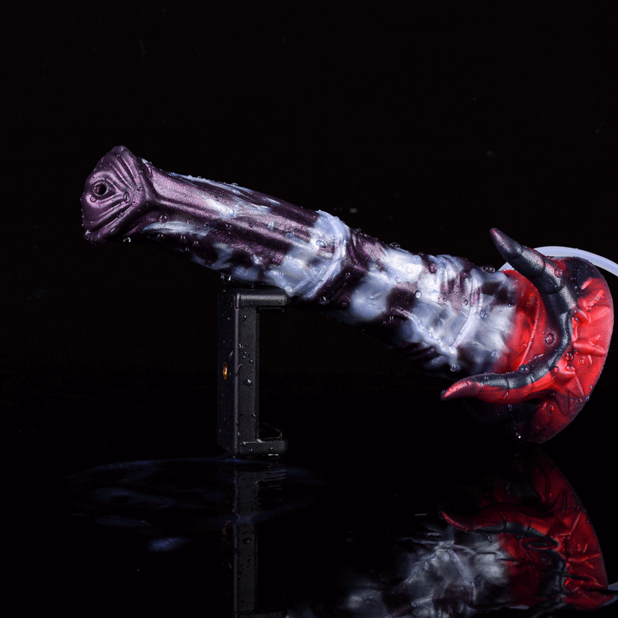 Fantasy beast adult toy with marbled purple/white body, red spiked base, on stand