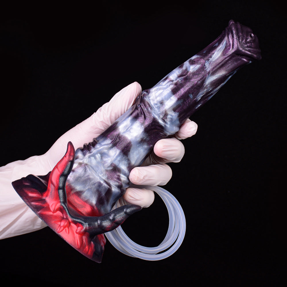 Gloved hand holding fantasy beast squirting dildo, red clawed base visible