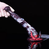 Handheld view of purple-gray fantasy squirting dildo with red horned base