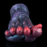 Blue dragon talon sex toy with red claw tips and textured ridges, close-up