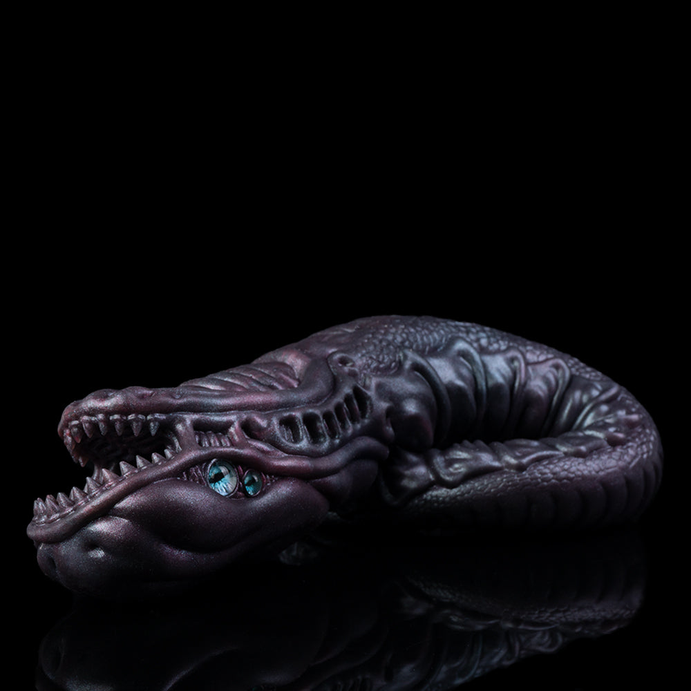 Side view of sculpted snake creature toy with blue eyes, dark purple curled body