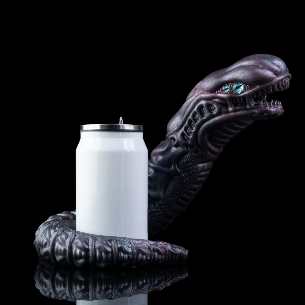 Snake creature toy with blue eyes holding a white container, dark purple coiled body