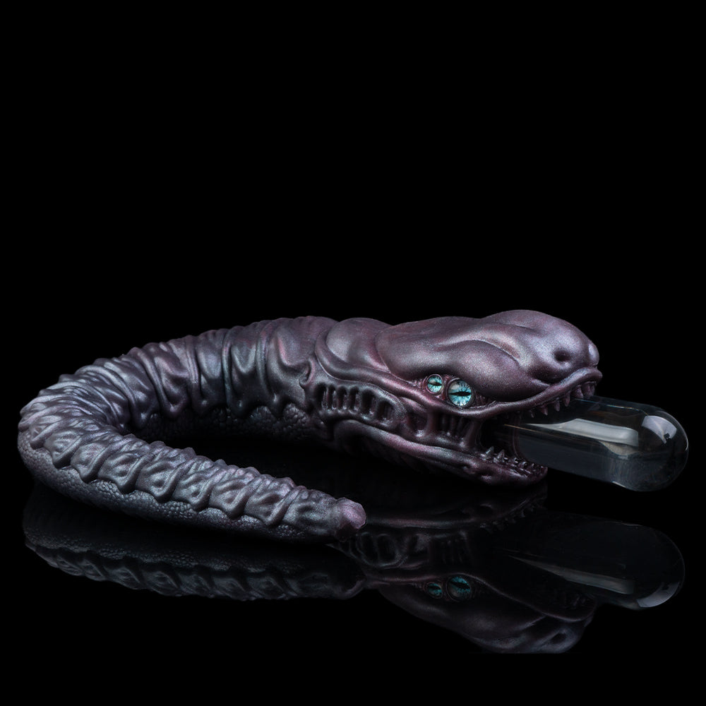 Sculpted snake creature toy with blue eyes and open jaw, coiled body in dark purple